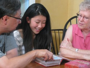 Eve, Hubert and Vivian muse over the 1995 album - photos shot when she was first adopted from China.